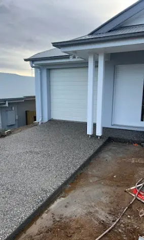 Exposed aggregate driveway in front of a new double garage