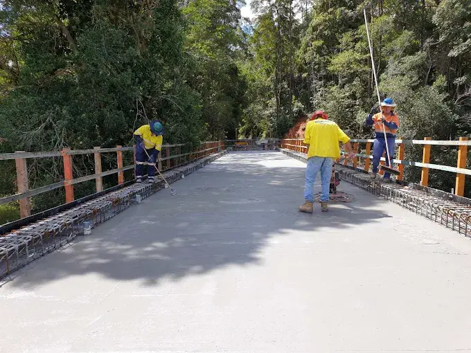 Crew finishing a concrete bridge deck