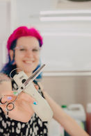 liz holding her favorite clippers and scissors out in front of her