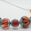 Thumbnail: purple, coral pink and silver handmade lampwork glass bead necklace view 6