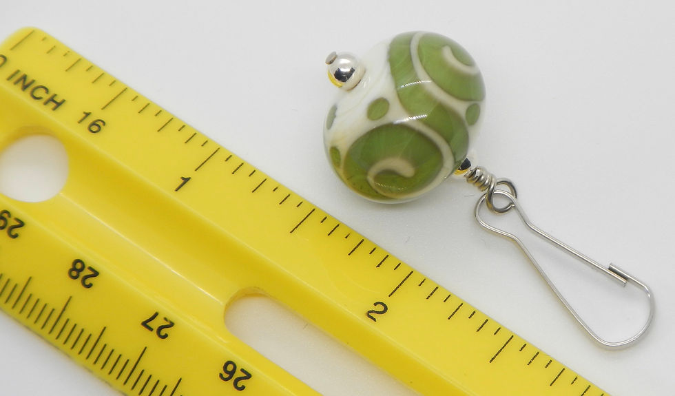 Thumbnail: zipper pull, spirals, ivory and green, with ruler