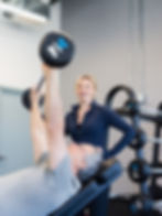 Customer and Personal trainer working out at River East Chiropractic
