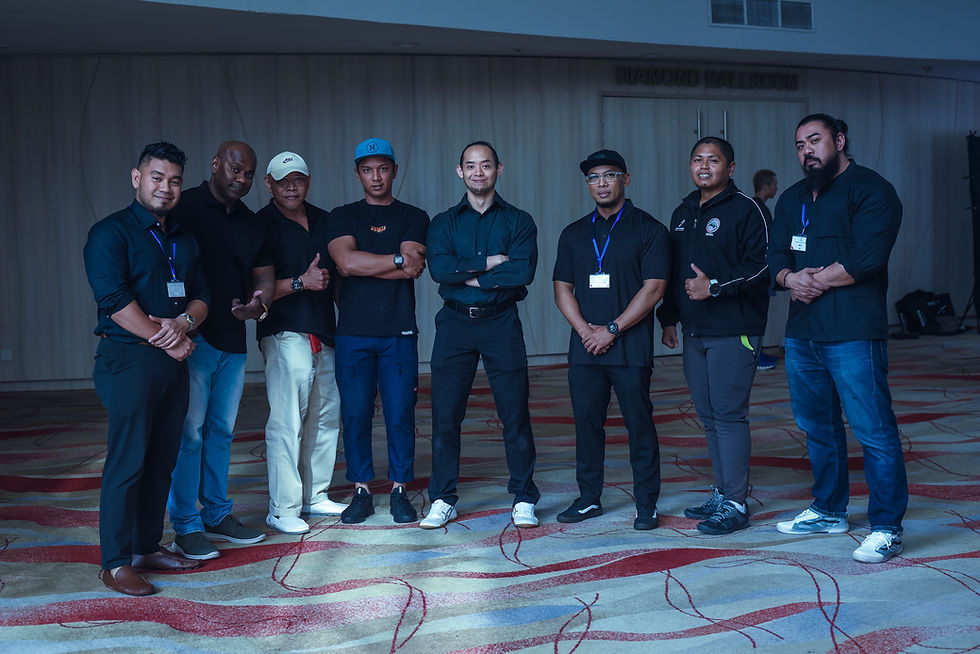 Wide landscape group photo of a fitness team standing in a row indoors
