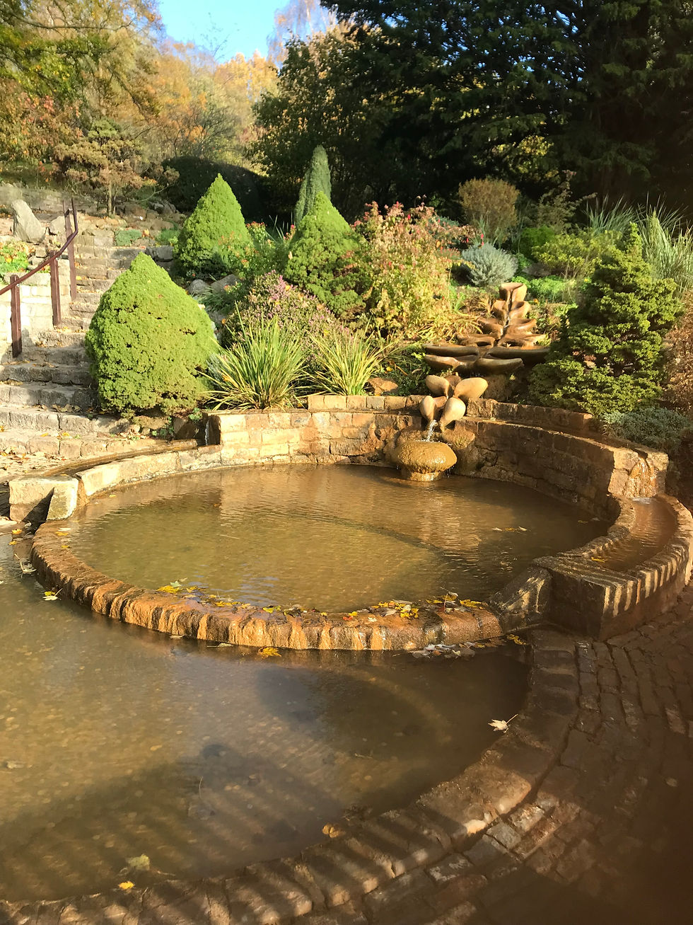 Flowing sacred spring water in Chalice Well gardens Glastonbury for Divine Feminine healing blog