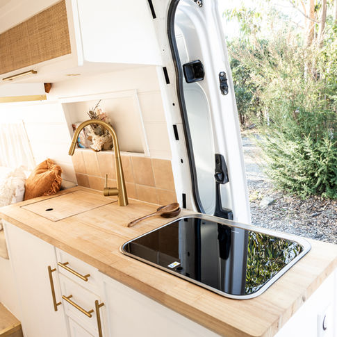 Fine Cabinetry: "Fine cabinetry and woodwork in the Mercedes Sprinter camper van, exemplifying luxurious craftsmanship."