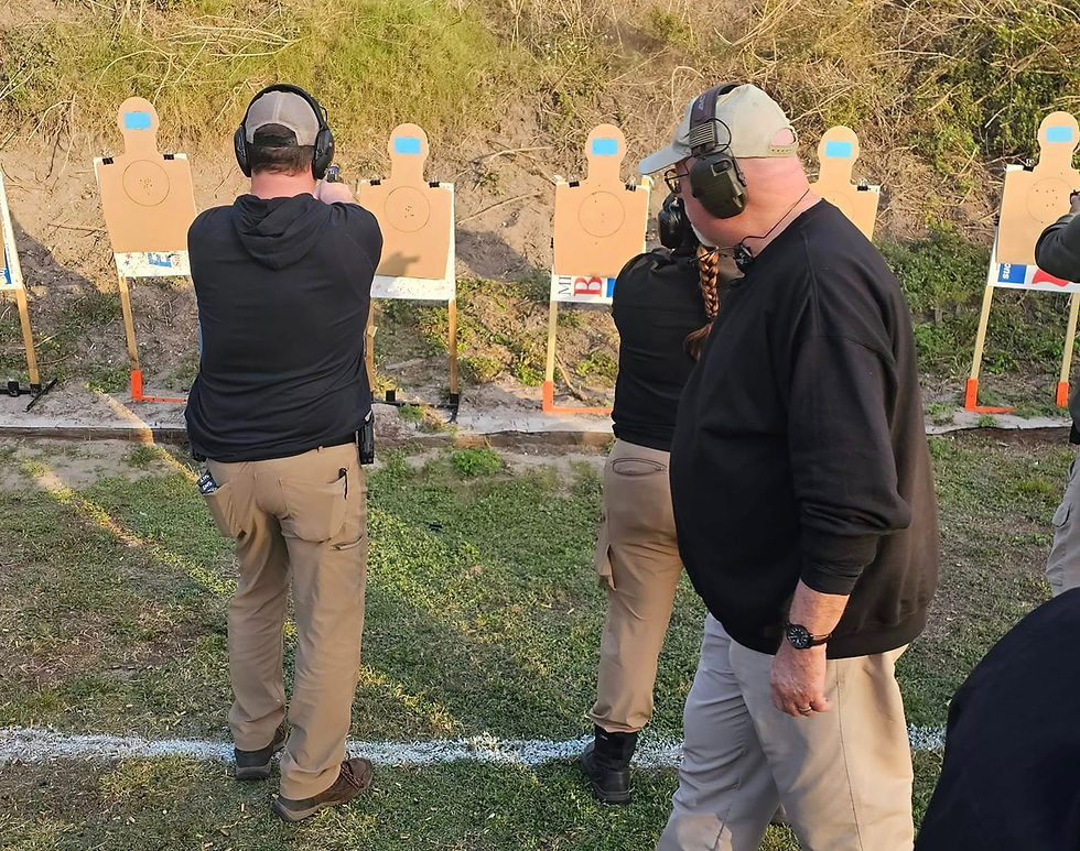 Close-up view of a firearm training session with instructor guiding a student