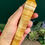 Thumbnail: hand holding aYellow Calcite Crystal Wand