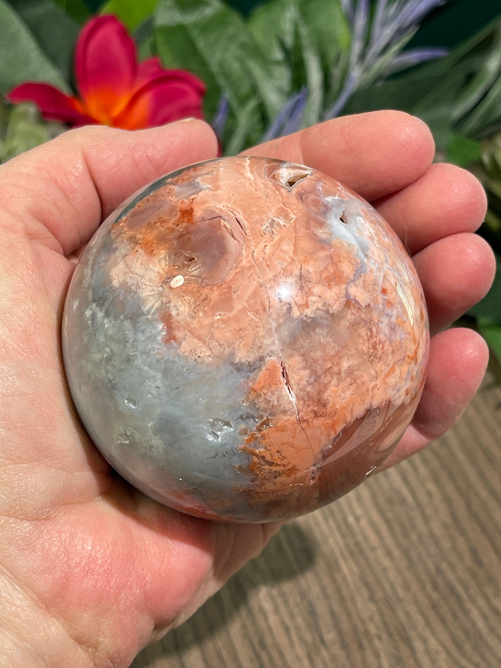 hand holding a Unique Pink Agate Sphere