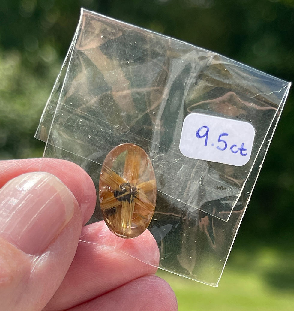 hand holding golden rutile half star in cellophane bag