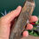Thumbnail: hand holding Tigers eye tower