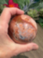 hand holding a Unique Pink Agate Sphere