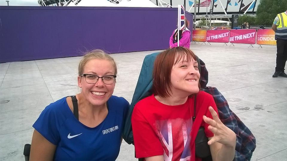 Hannah Cockroft and Ailsa. Ailsa is wearing a red Union Jack t-shirt, Hannah Cockroft is wearing a blue t-shirt with the 'Nike' logo at the left, and 'GREAT BRITTAIN' written at the top right (Both white). Purple wall straight behind us. 'London 2017' and 'Be The Next' banners at the left.