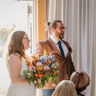 The bride and groom enter the reception together hand-in-hand