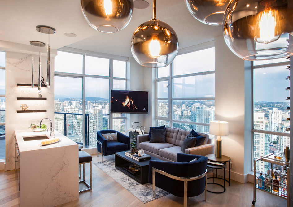 Luxury penthouse living room and kitchen overlooking Vancouver skyline.