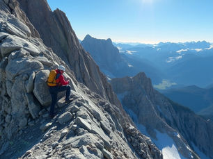 A mountaineer cilmbing a very high mountain.