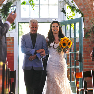 Bride entering her ceremony at Brick