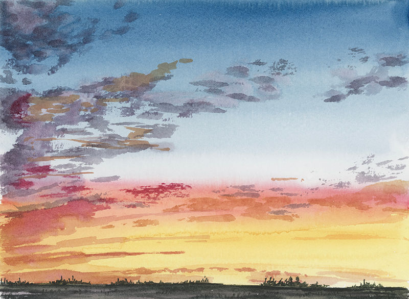 A sunset with bright yellows, oranges, reds merging into blues and purples over a dark green tree lined field.