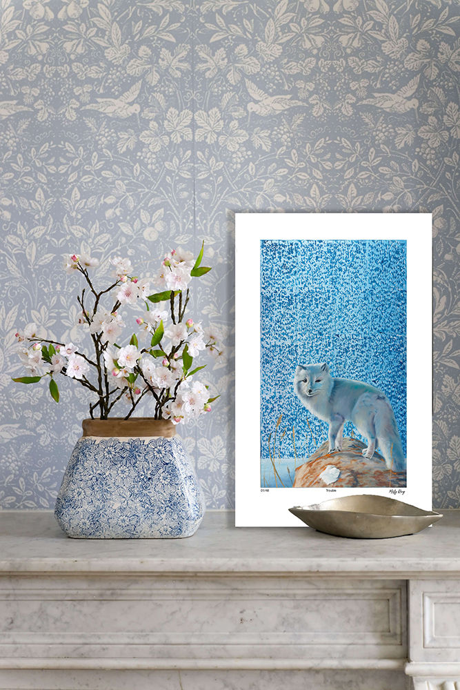 Arctic fox canvas displayed on a wall beside a white chair.