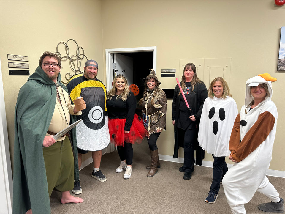 Employees dressed in costumes like ghosts, a poke ball, Darth Vader, ladybugs and a wizard. 
