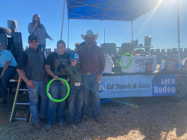 Group at Ed Staub & Sons booth promoting propane services at a rodeo event.