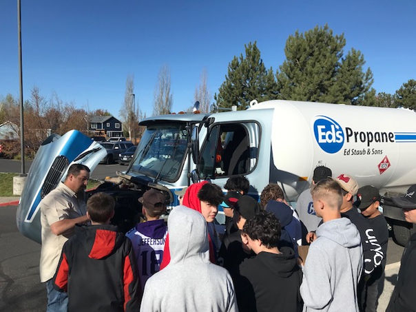 Ed Staub & Sons employee teaching middle school students at a school