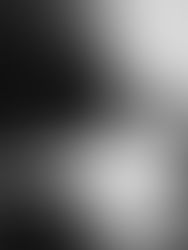 Abstract black-and-white glitch image with bright horizontal light streaks and blurred dark shapes, eerie and static-like
