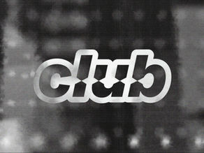 White Club logo on a blurred black-and-gray background, likely a window decal or sign.