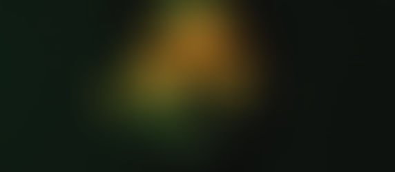 Close-up of a man's face lit with green and yellow hues against a dark background, creating a dramatic and contemplative mood.