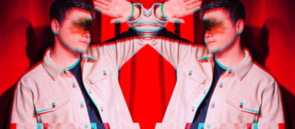 Mirrored young man in a white jacket against red curtains, hand raised to his forehead in a stylized glitch effect.
