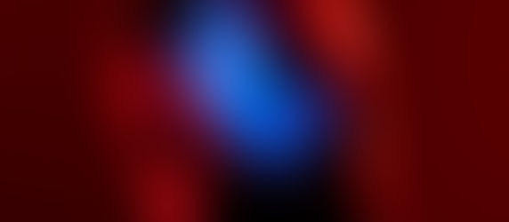 Bearded man in profile, highlighted by vibrant red and blue lighting, creating a dramatic and intense mood.