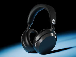 Black over-ear headphones on a blue-lit surface against a black background, with Sennheiser logo visible