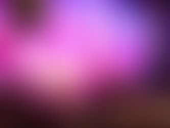 DJ performs energetically on stage with colorful lights and "SHINE IBIZA" backdrop. Audience raises hands and phones, creating a lively atmosphere.