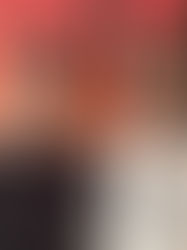 Two men wearing sunglasses and lanyards smile in front of an orange and black background with large text. One wears a Bulls shirt.