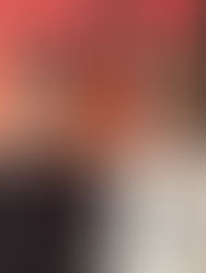 Two men wearing sunglasses and lanyards smile in front of an orange and black background with large text. One wears a Bulls shirt.