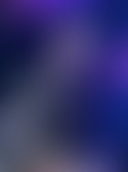 Man in a cap sits in a dimly lit studio with glowing lights and equipment. Background features fairy lights and purple accents. Serious mood.
