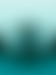 DJ seen from behind on a small black platform with turntables and speakers, in a minimalist teal-lit room, calm and solitary.