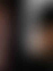 Two men in profile, one smiling with glasses on black background, the other with a beard and black cap labeled "Techno" on light gray.