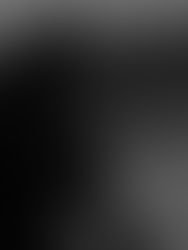 Person in a black hoodie holds headphones by a pool at dusk. The background shows a blurred landscape, creating a calm, introspective mood.