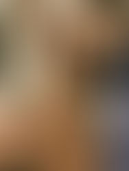 Two men looking down towards the camera with serious expressions, wearing casual jackets. Brick wall in background suggests urban setting.