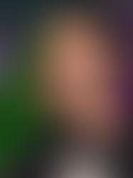 Man with sunglasses and headphones in front of vibrant green and purple floral background. Happy expression, wearing a black jacket.