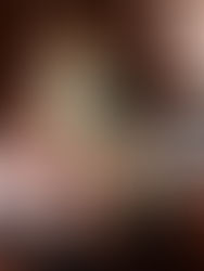 Five people in oversized jerseys with the number 33 pose on a brown leather couch. Dimly lit wood-paneled room, relaxed vibe.