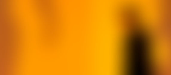 Man in black jacket walks against a vibrant orange background. Shadows of figures and hands appear on the wall, adding intrigue.