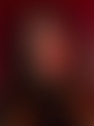 Woman with closed eyes in a contemplative mood, set against a dark red background. She has long, dark hair and wears a black outfit.