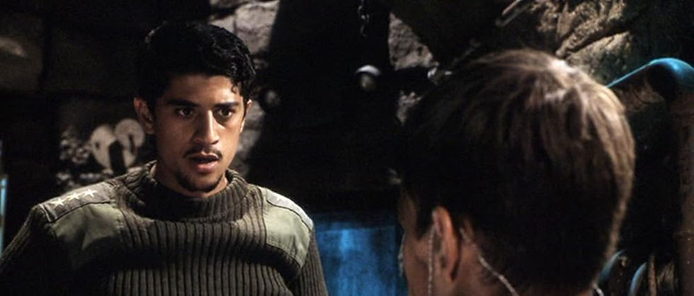 Captain Said interrogates Troy in a cave in 'Three Kings'.