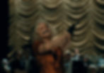 The Bride, ink-spattered at the mouth, aims a gun over a crowd.