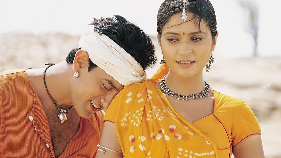 A man with a scarf wrapped around his head leans his head against the shoulder of a woman dressed in yellow.