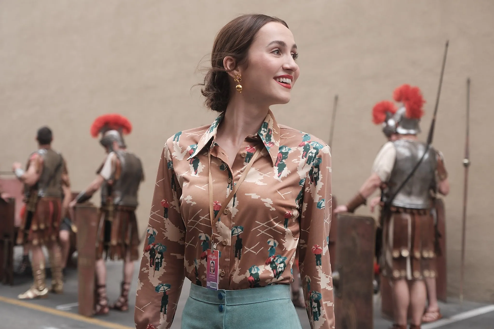 Lexi looks hopeful in front of a bunch of film extras dressed as Spartans.
