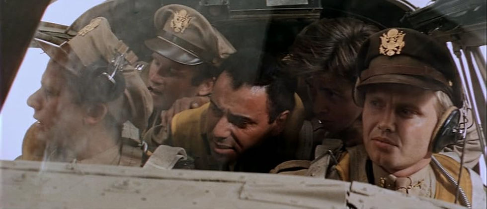 A group of fighter pilots sit crammed into the front seat of an airplane.