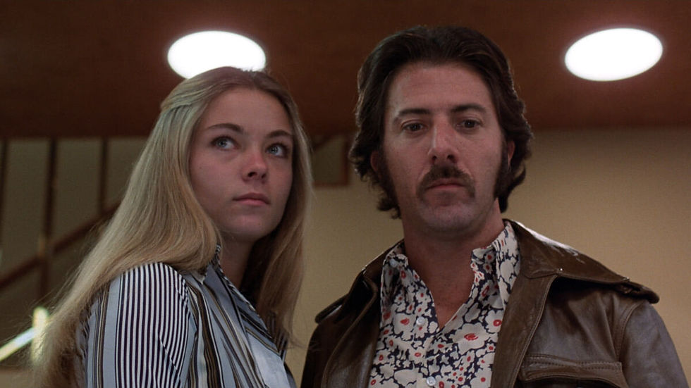 A medium interior shot of Jenny and Max, the latter of whom looks disturbed.