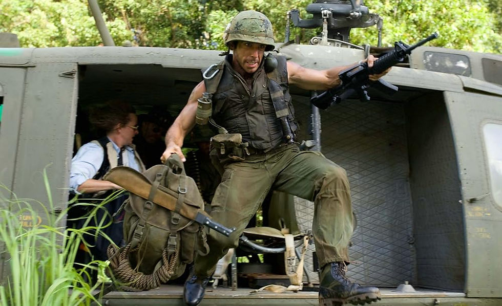 A soldier jumps out of a helicopter with a machine gun and backpack.